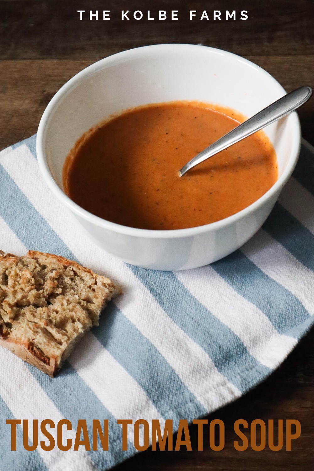 tuscan tomato soup in a white bowl on a blue striped towel