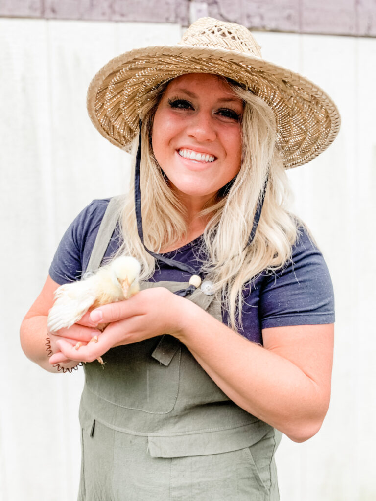 city girl becomes a homesteader Holding a cornish broiler hen 
