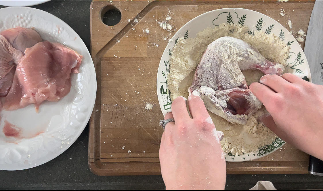 lathering chicken in einkorn flour in an antique bowl 