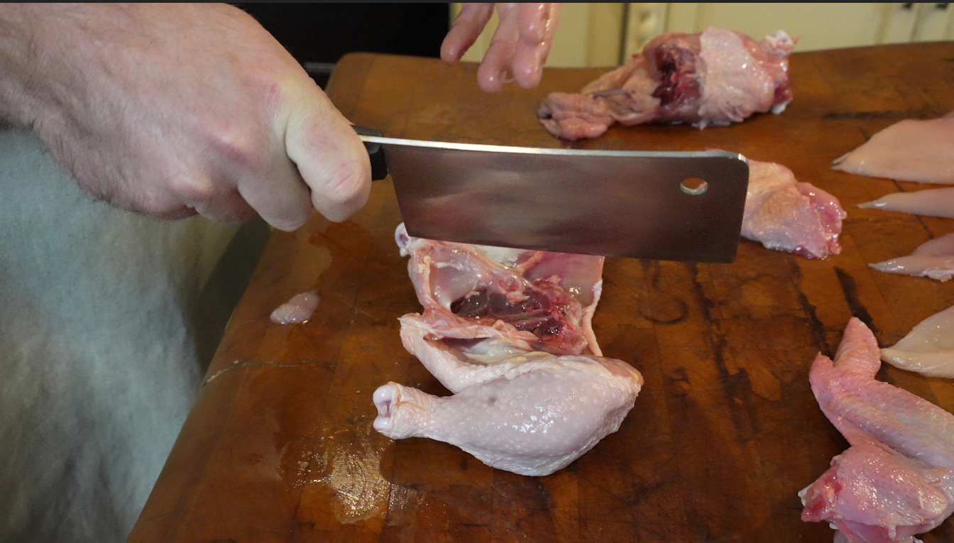 how to cut up a whole chicken on a butcher block. chicken cuts